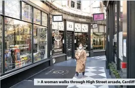  ??  ?? > A woman walks through High Street arcade, Cardiff