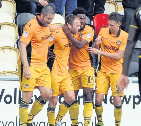  ??  ?? Newport Couty’s Sean Rigg (centre) celebrates his equaliser against Crewe yesterday