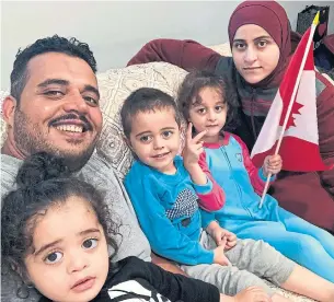  ??  ?? Mokhles Abdulghani, wife Hajir Saad Ghareeb and their three children Razan, Alwaleed and Asia, arrived in their new home of Morden, Man., on Saturday. After spending five years in limbo in Jordan, the Iraqi family was selected by a pilot program that brings skilled workers to Canada.