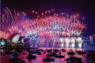  ?? Bianca De Marchi/Australian Associated Press ?? Fireworks explode over the Sydney Opera House and Harbour Bridge early Sunday to mark New Year’s. More than 1 million people crowded along Sydney’s waterfront to join the celebratio­n.