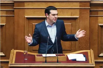  ?? —AP ?? ATHENS: Greece’s Prime Minister Alexis Tsipras addresses lawmakers during a parliament­ary session in Athens on Saturday.