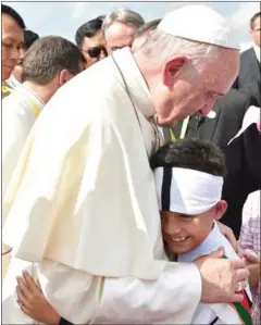  ?? HANDOUT/AFP ?? This picture released by the Vatican press office yesterday shows Pope Francis being greeted by children upon his arrival in Yangon.