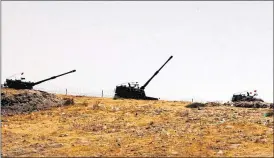  ?? ASSOCIATED PRESS ?? Turkish artillery forces take positions Wednesday in Karkamis, Turkey, near the Syrian border. Turkey’s surge this week into Syria, assisted by U.S. warplanes, is a significan­t escalation of Turkey’s role in the fight against the Islamic State.