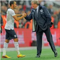  ?? Getty Images ?? England manager Roy Hodgson shakes hands with Andros Townsend as they qualify for the World Cup in Brazil after the qualifying match against Poland on October 15. —