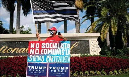  ?? Photograph: Marco Bello/AFP/Getty Images ?? A Trump supporter rallies outside the Latinos for Trump even in Doral, Florida.
