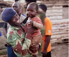  ??  ?? Zimbabwe National Army soldier holds a child at a Cyclone Idai victims camp in Chimaniman­i recently.