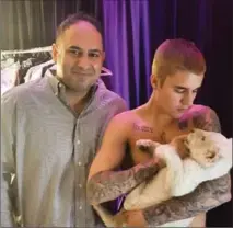  ?? INSTAGRAM, THE CANADIAN PRESS ?? Toronto Animal Services said Friday it has sent singer Justin Bieber a notice of violation after receiving two complaints he "exhibited" lions at two events in Toronto. He is seen here cradling a lion cub.