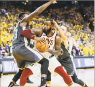  ?? Carlos Avila Gonzalez / The Chronicle ?? The Warriors’ Draymond Green, left, and Stephen Curry defend against LeBron James during Game 2 of the NBA Finals on Sunday.