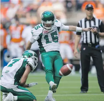  ?? THE CANADIAN PRESS/ DARRYL DYCK ?? Saskatchew­an Roughrider­s’ Paul McCallum kicks an extra point convert as Weston Dressler holds. The rule change for extra points is having the desired effect in the league so far.