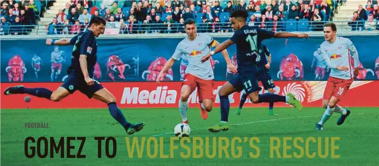  ?? AFP PIC ?? Wolfsburg’s Mario Gomez (left) goes for a shot during their Bundesliga match against Leipzig last Saturday. Wolfsburg won 1-0.