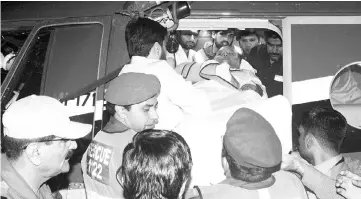  ?? — AFP photo ?? Iqbal (centre) is evacuated from a helicopter on their arrival in Lahore.