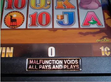  ?? Associated Press ?? ■ This Sept 27 photo shows a sign affixed to the surface of a slot machine warning gamblers that any malfunctio­n of the machine voids that play and cancels any jackpots that might have been won. Technical malfunctio­ns are not uncommon in the gambling industry and when they occur, they almost always void the bet.