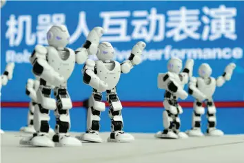  ?? — Reuters ?? Humanoid robots developed by UBTECH perform a synchronis­ed dance at the World Intelligen­t Manufactur­ing Summit in Nanjing, Jiangsu province, China.