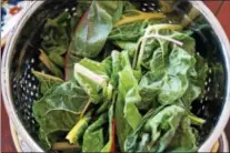  ?? PHOTO BY EMILY RYAN ?? Rainbow Swiss chard fills a colander.