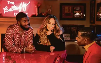  ?? RCA Inspiratio­n ?? Khalid (left) and Kirk Franklin join Mariah Carey for her new holiday song, “Fall in Love at Christmas,” which also features a vocal contributi­on from Franklin’s gospel choir.