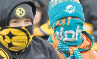 ?? JIM RASSOL/STAFF PHOTOGRAPH­ER ?? Steelers and Dolphins fans braved freezing temperatur­es at Heinz Field to see their teams play on Sunday. With the loss, the Dolphins will have the 22nd pick in this year’s draft.