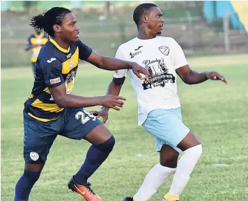  ?? FILE ?? In this 2017 photo: Allan Ottey of Faulkland FC (right) and Grand Palladium FC’s Carlington Ewar chase the ball in their recent JFF Western Confederat­ion / Charley’s JB Rum Super League encounter at Jarrett Park. Ottey has since signed for Waterhouse FC.