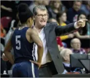  ?? CHRIS SZAGOLA — THE ASSOCIATED PRESS ?? Connecticu­t’s head coach Geno Auriemma, right, instructs Crystal Dangerfiel­d, left, during the first half of an NCAA basketball game against Temple, Sunday in Philadelph­ia.