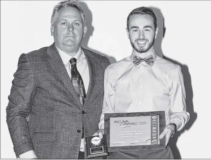  ??  ?? Neil Hooper, left, president of the Atlantic Collegiate Athletic Associatio­n, presents the 2018 Rookie of The Year Award to Connor Grant.