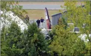  ?? JOSEPH FREDERICK - THE ASSOCIATED PRESS ?? In this still image from video, members of the National Transporta­tion Safety Board walk near the tail in the wreckage of a World War II-era B-17 bomber plane on Thursday, at Bradley Internatio­nal Airport in Windsor Locks, Conn., that crashed there Wednesday.
