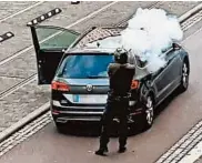  ?? ANDREAS SPLETT/ATV-STUDIO HALLE/GETTY-AFP ?? A man fires a weapon in Halle, eastern Germany, on
Wednesday. Police said two people were shot dead.