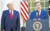  ?? ALEX BRANDON/AP ?? MyPillow CEO Mike Lindell speaks as President Donald Trump listens during a briefing about the coronaviru­s last March at the White House.