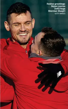  ?? GETTY IMAGES ?? Festive greetings: Dejan Lovren (left) hugs Xherdan Shaqiri