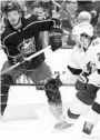  ?? JAY LAPRETE/AP ?? The Blue Jackets’ Jack Roslovic, left, passes the puck around the net as the Lightning’s Brayden Point defends during the second period Thursday in Columbus, Ohio.