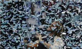  ?? Photograph: Kirsty Wiggleswor­th/AP ?? Stefanos Tsitsipas holds up the trophy as confetti falls after his defeat of Dominic Thiem.