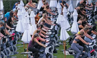  ?? (The New York Times/Stefani Reynolds) ?? People take part in an outdoor spin class Tuesday in West Palm Beach, Fla. Gov. Ron DeSantis has said young, healthy front-line workers will not be put ahead of older people in the state’s vaccine plan.