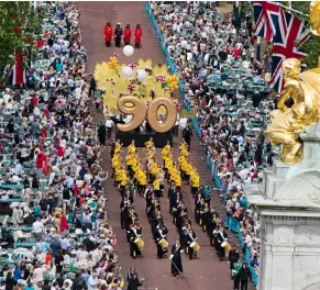  ??  ?? Clockwise from above: The Patron’s Lunch on The Mall celebrated the Queen’s patronage of more than 600 charities; laughing with Prince William; Princes William and Harry, and the Duchess of Cambridge applaud the Queen; the Queen and Prince Philip drive...