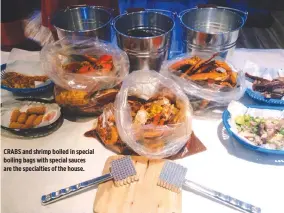  ??  ?? CRABS and shrimp boiled in special boiling bags with special sauces are the specialtie­s of the house.