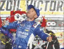  ?? IAN MAULE VIA AP ?? KYLE LARSON celebrates after winning a Cup
Series auto race at Las Vegas Motor Speedway on March 3 in Las Vegas.