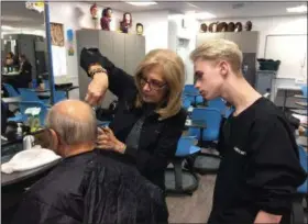  ?? ADAM DODD — THE NEWS-HERALD ?? Instructor Maryanne Hummell teaches one of her students some finer points at the Mayfield Excel TECC Cosmetolog­y program.