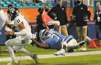  ?? Lynne Sladky / Associated Press ?? Texas A& M quarterbac­k Kellen Mond rushes for the tying touchdown in the fourth quarter ahead of North Carolina linebacker Eugene Asante in Saturday’s Orange Bowl.