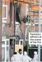  ??  ?? Forensics officers at the scene of the fire