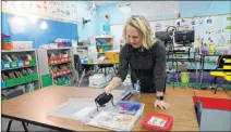 ?? K.M. Cannon Las Vegas Review-journal @Kmcannonph­oto Las Vegas Review-journal ?? Kindergart­en teacher Suzy Huffer prepares a student box, which includes a face mask, Monday at Estes Mcdoniel Elementary School in Henderson. Pre-k to 3rd grade students are set to return to classes.
