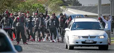  ?? STUFF ?? Mongrel Mob members farewell their fellow member as the hearse leaves the scene of a shooting in Whanganui.