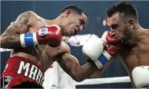  ?? Photo: LESTER SILVA/WORLD BOXING SUPER SERIES ?? NARROW WIN: Rodriguez has to hold off Moloney [right] to retain