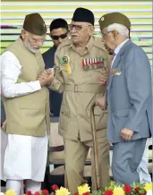  ?? — PTI ?? Prime Minister Narendra Modi with INA veteran Lalti Ram during a flag hoisting ceremony to mark the 75th anniversar­y of the “Azad Hind government” at Red Fort in New Delhi on Sunday.