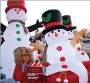  ?? TIMES photograph by Annette Beard ?? Inflatable snowmen adorned a float during the annual Christmas parade.