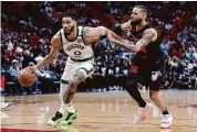  ?? Megan Briggs/Getty Images ?? Jayson Tatum of the Boston Celtics drives against Caleb Martin of the Miami Heat during the first quarter of the game at Kaseya Center on Sunday.