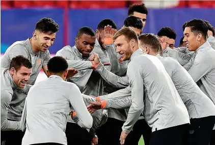  ?? GETTY IMAGES ?? Part of the crowd: Sturridge (fourth left) and Liverpool team-mates training last night