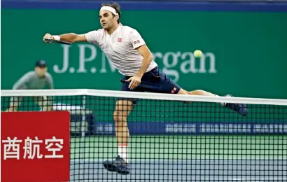  ?? Reuters ?? Roger Federer plays a shot against Kei Nishikori during the Shanghai Masters on Friday. —