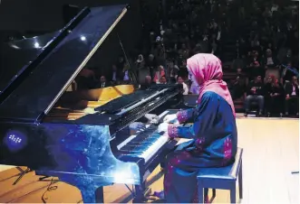  ?? ADEL HANA/THE ASSOCIATED PRESS ?? Pianist Yara Thabit performs during a concert this week to mark the debut of Gaza’s only grand piano after it was saved from conflict and refurbishe­d.