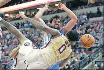  ?? [STEVE CANNON/THE ASSOCIATED PRESS] ?? Florida State’s Phil Cofer fouls North Carolina’s Luke Maye in the second half of the Seminoles’ 81-80 victory.