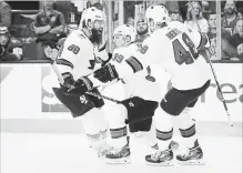  ?? JOHN LOCHER
THE ASSOCIATED PRESS ?? Sharks’ Logan Couture, centre, celebrates after scoring the winning goal against the Vegas Golden Knights. San Jose won the contest, 4-3.