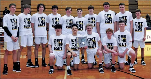  ?? Photo by Mike Frank ?? Members of the Botkins boys basketball team pose with the trophy after winning the district championsh­ip on Saturday over Fayettevil­le-perry in a game at Vandalia. the trojans actually cut down the nets later in the day at their own gym since that part was not held at Butler due to other games.