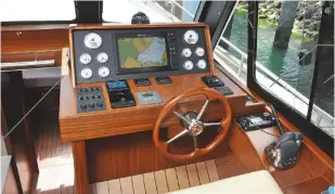  ??  ?? DASHING The dashboard is clear and unfussy, though the flat panels can be tricky to read when sitting WINDOW The simple sliding window is a useful addition at the helm TAKE A SEAT The ergonomics at the lower helm are much better than on the flybridge