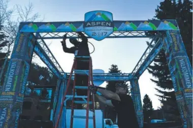  ?? Helen H. Richardson, The Denver Post ?? Shane Allen, left, and Todd Hartley, of Alchemy Production Company, hang lights Tuesday on entrance scaffoldin­g in the World Cup Village at Aspen’s Wagner Park.